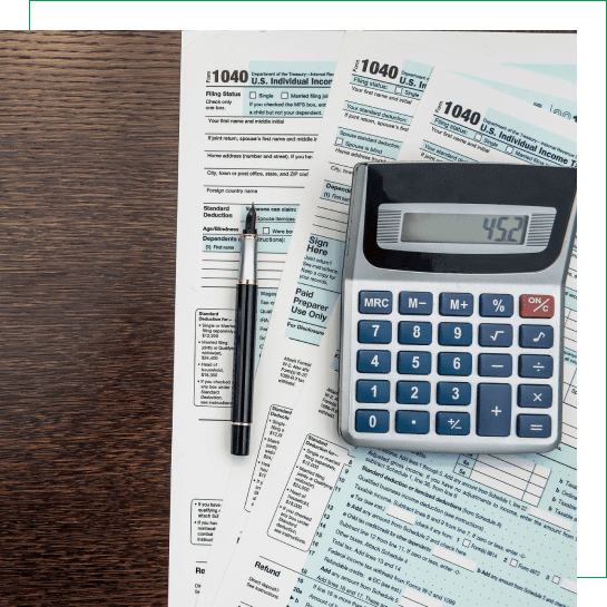 Calculator and pen on tax forms.