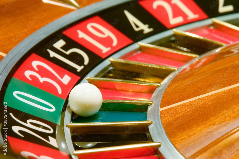 A roulette wheel with a white ball landing on number 19.