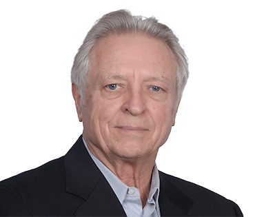 Portrait of an elderly man in a suit against a white background.