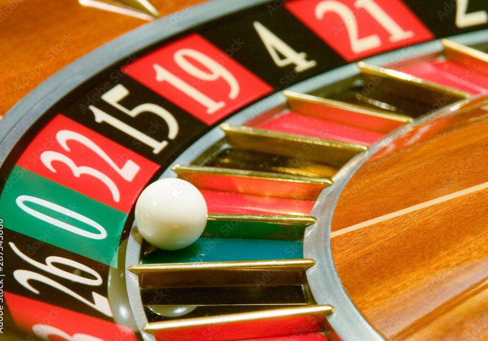 A roulette wheel with a white ball landing on number 19.
